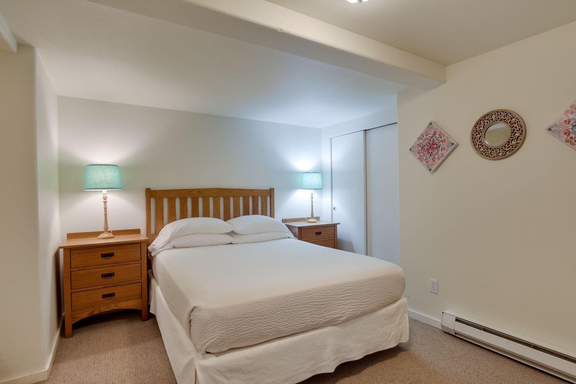A bedroom with a king size bed and two nightstands