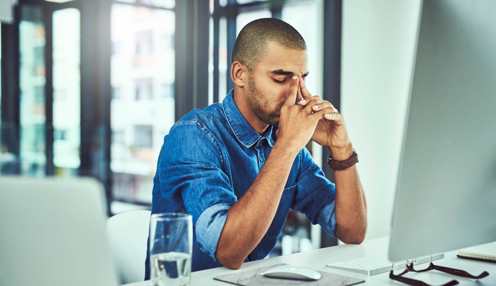 Burned‑out office worker swapping a suit jacket for a Mastertech Environmental polo, ready to start life as a franchise owner.