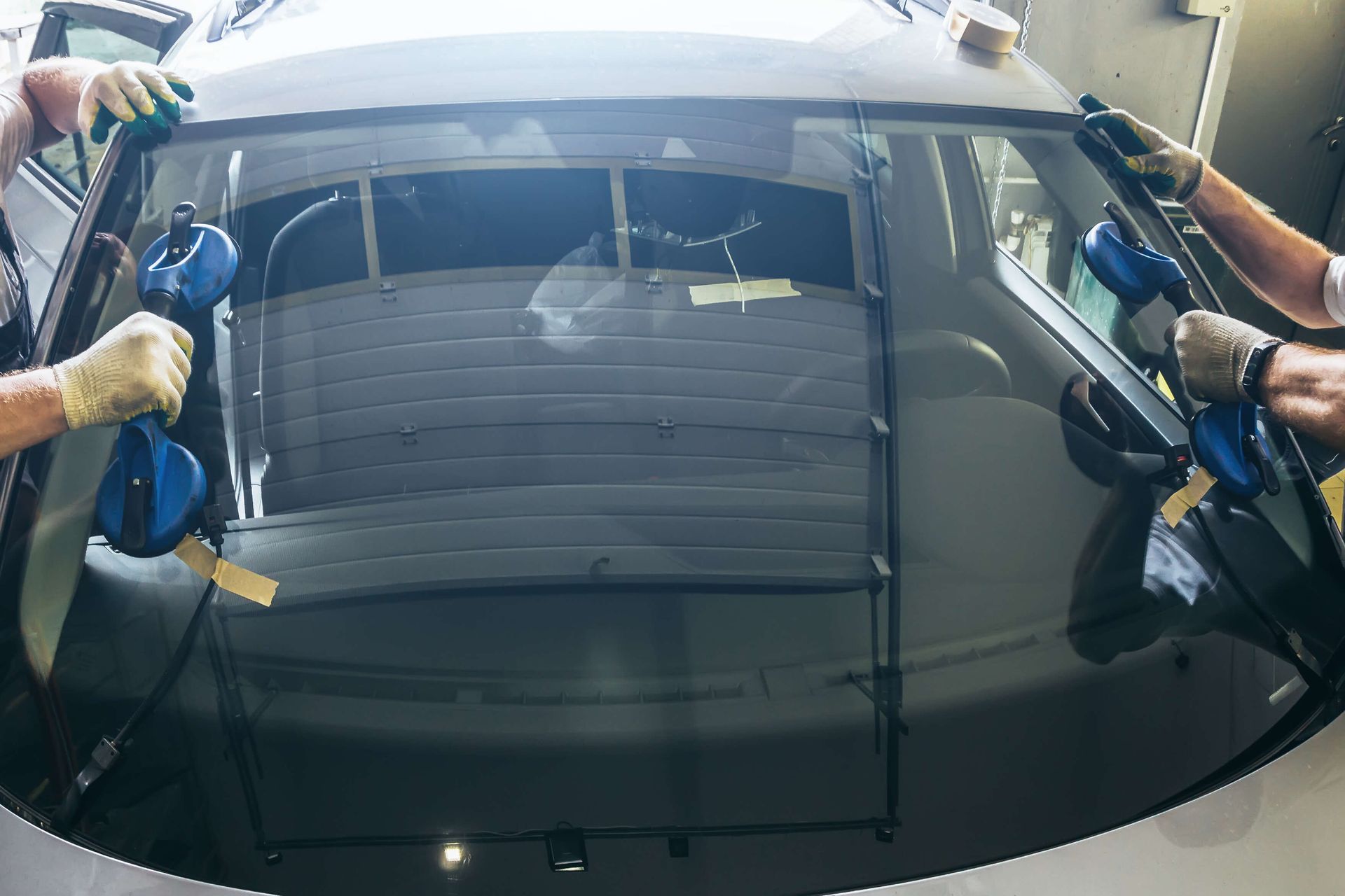 an expert replacing car front windshield