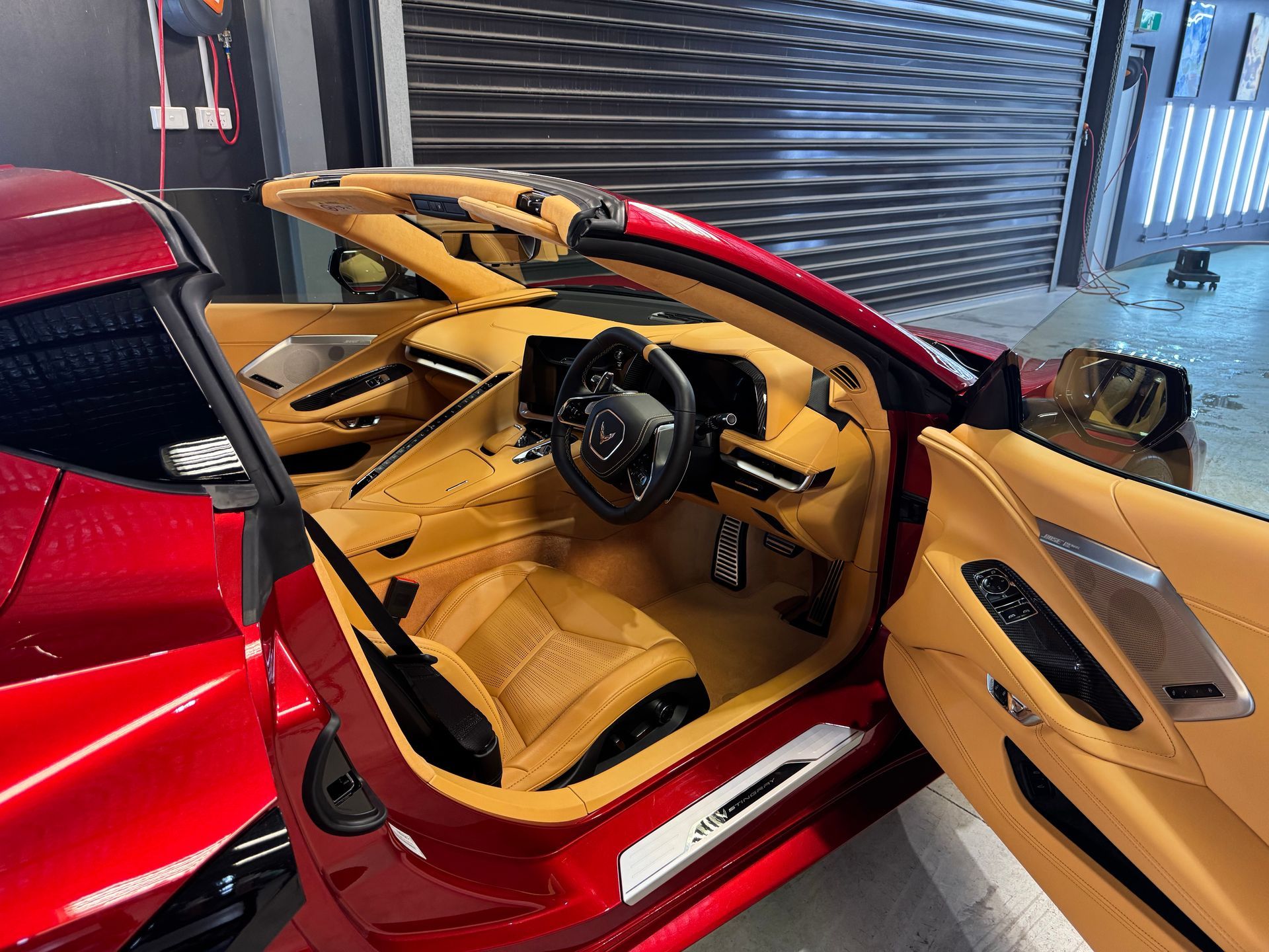 A Person Is Cleaning The Steering Wheel Of A Car With A Brush — The Works Auto Salon In East Bendigo, VIC