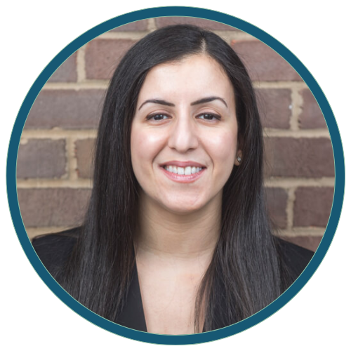 Portrait of a smiling woman in front of a brick wall, framed by a teal circular border