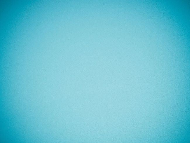 Soft blue-green gradient background with a lighter glow near the center.