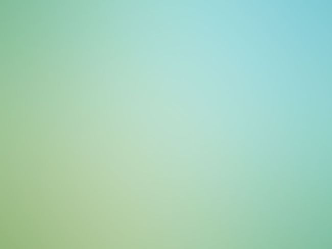 Abstract teal circular logo with concentric rings on a pale green background