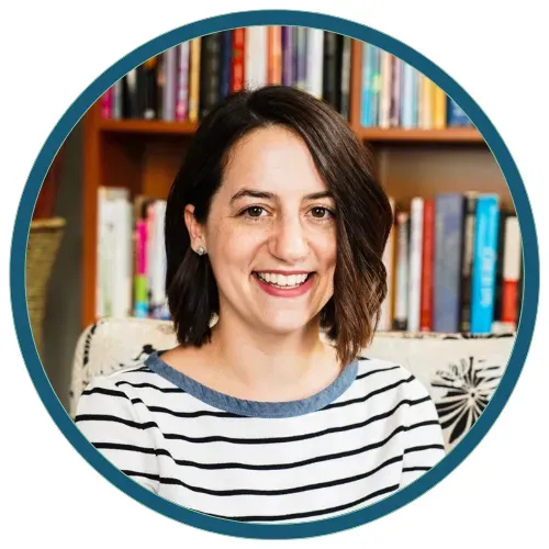 Smiling woman in a striped shirt in front of a bookshelf, framed by a teal circular border