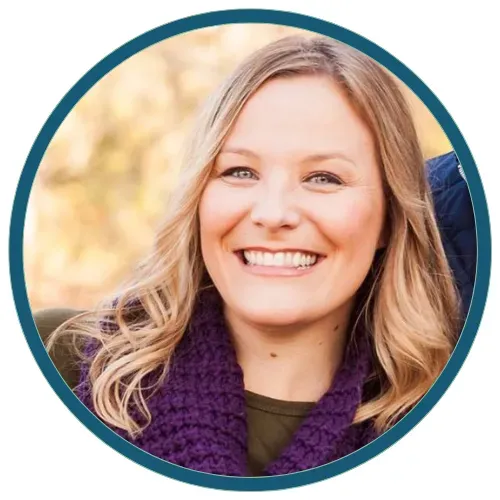 Smiling woman in a purple scarf outdoors, framed in a teal circle