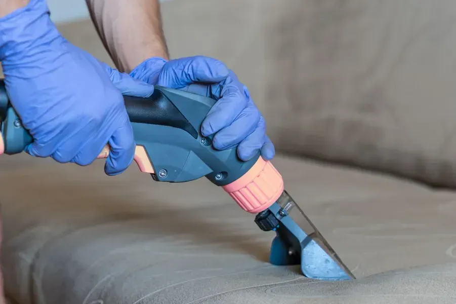 Person in Blue Gloves Using a Carpet Cleaner — Phil Lindfield's Big Red Carpet Cleaning In Tallwoods Village, NSW