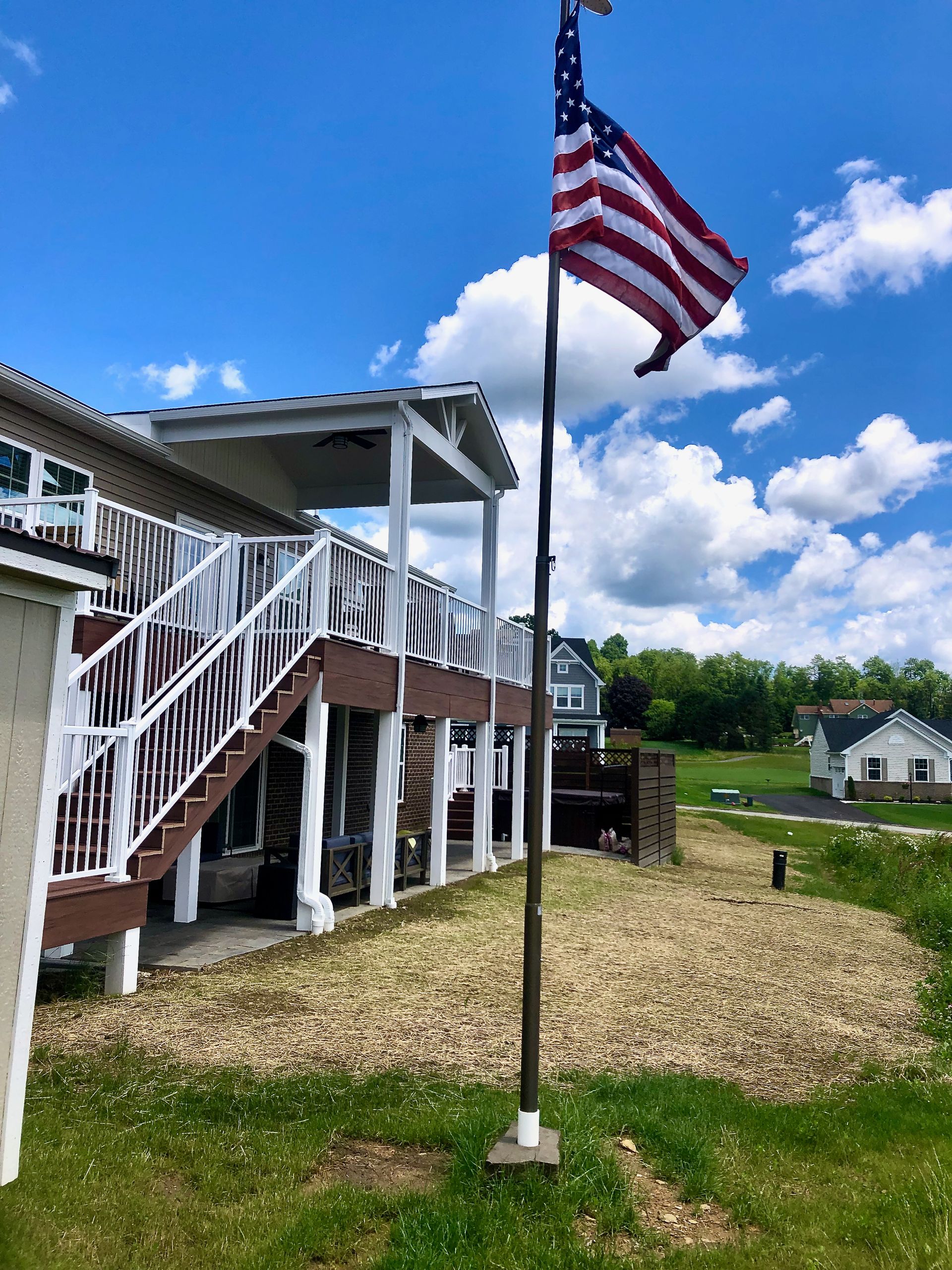 An american flag is flying in front of a house
