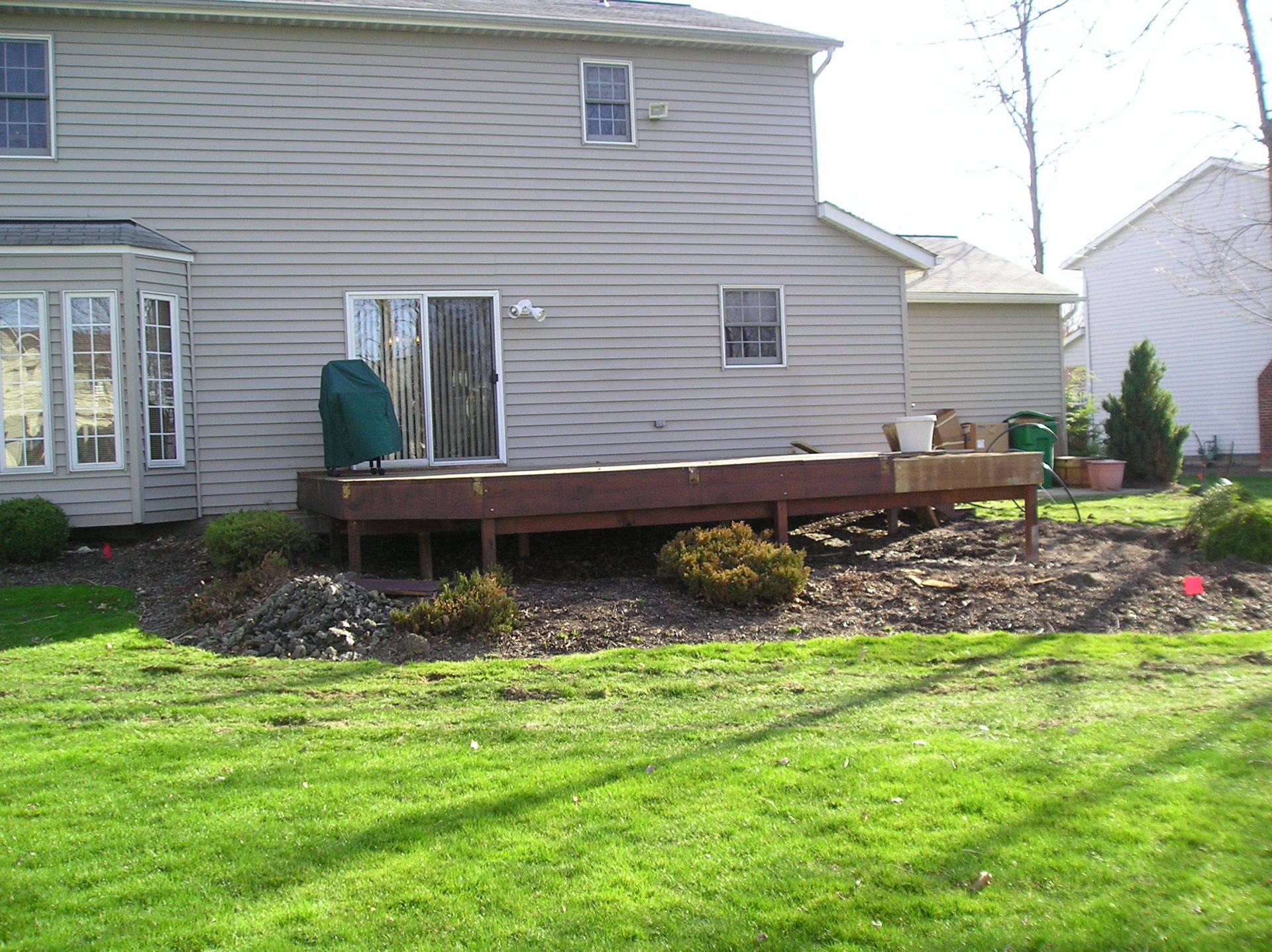 A house with a wooden deck in front of it