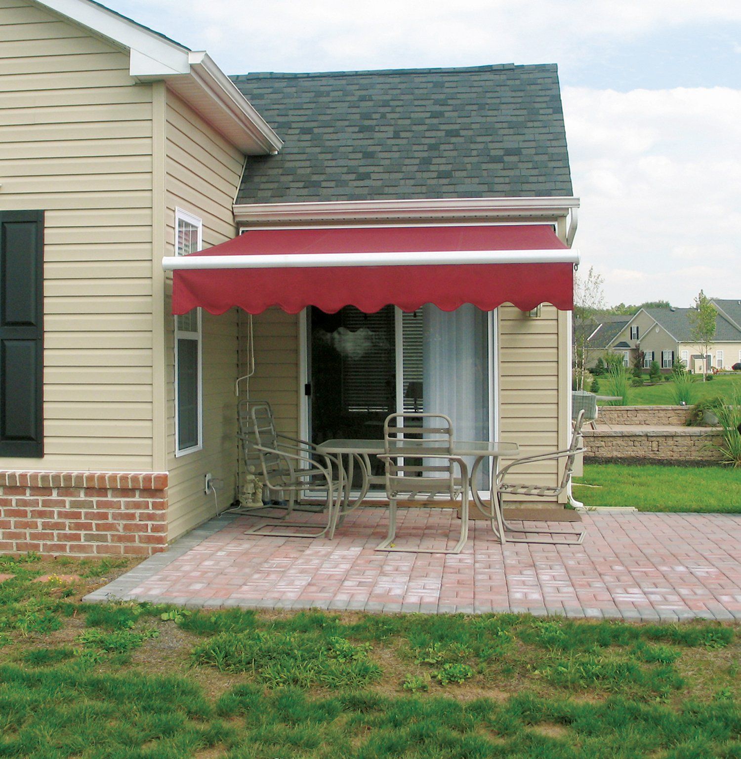 A house with a red awning over a table and chairs