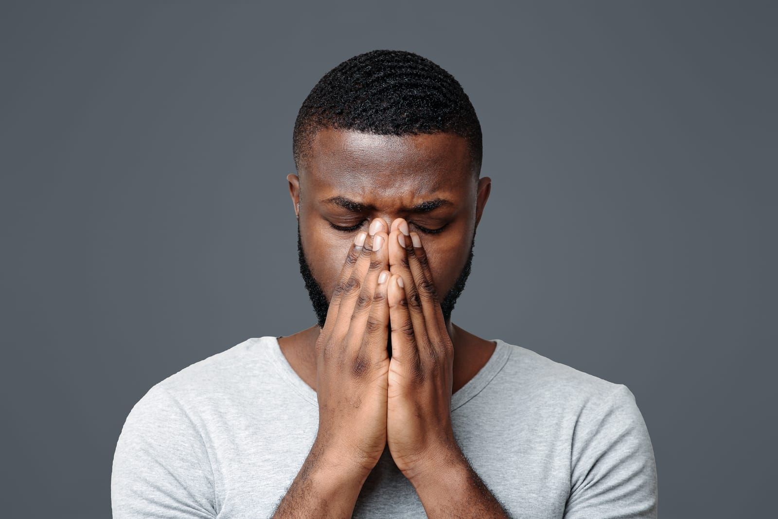 sad-black-man-holding-his-nose-because-sinus-pain