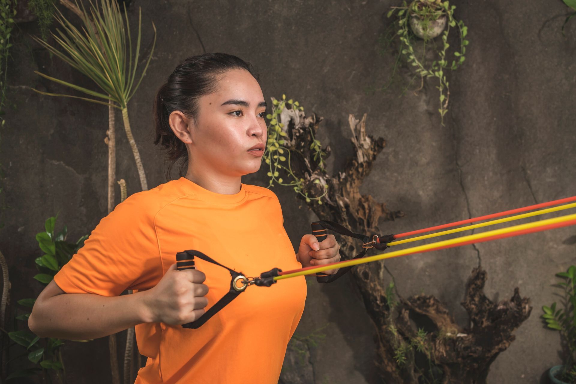 Woman using a resistance band doing a horizontal pull.