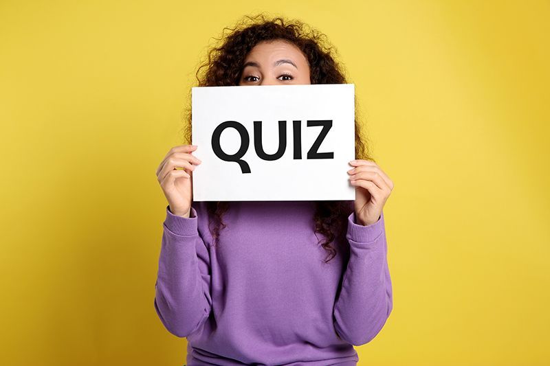 Woman Holding Quiz Sign