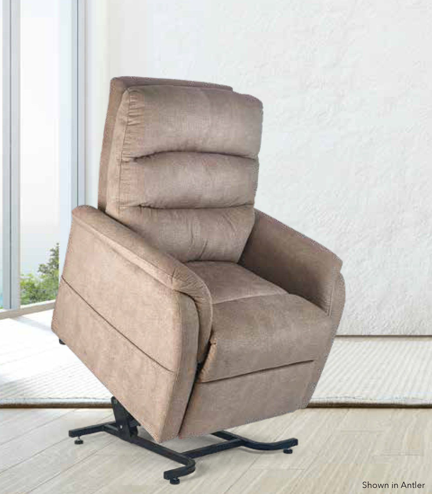 A recliner is sitting in a living room next to a window.