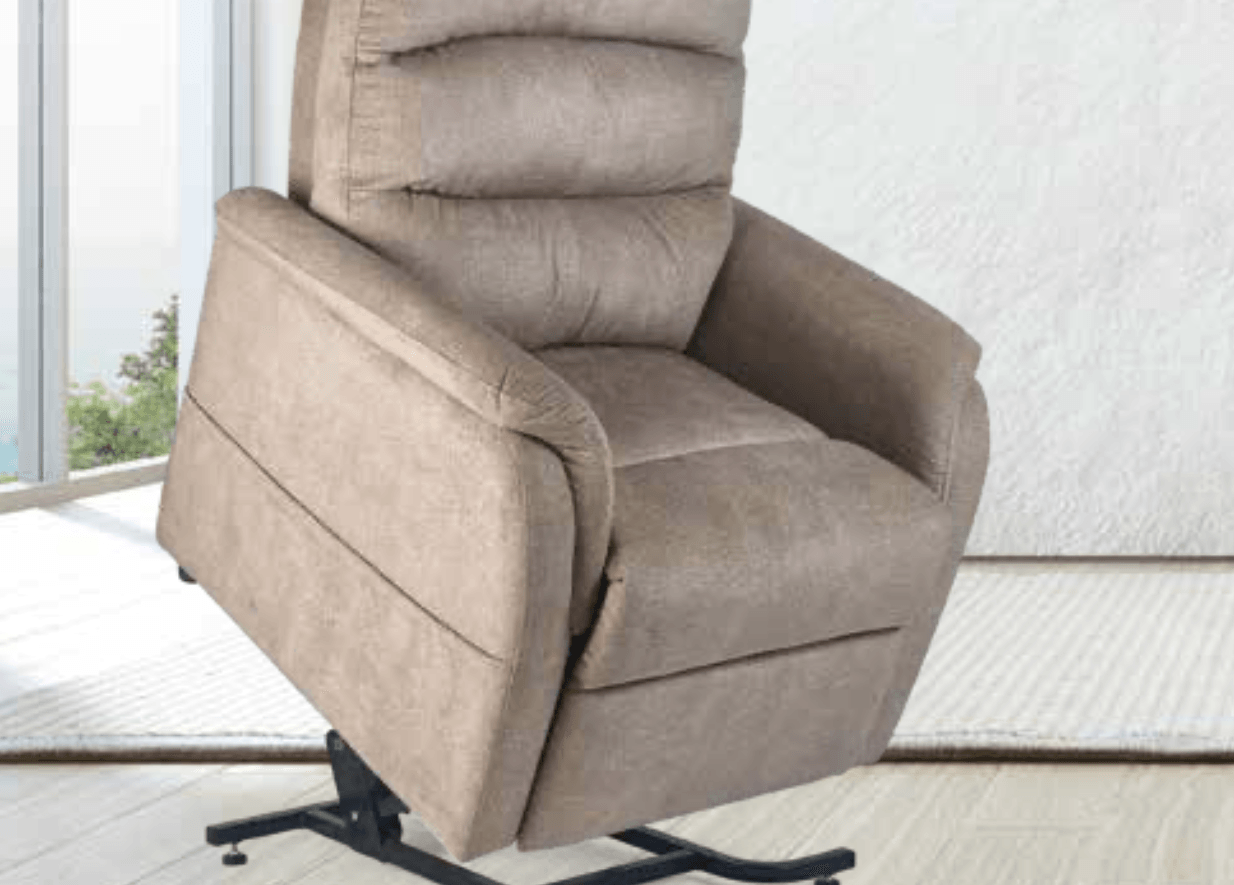 A beige recliner is sitting in a living room next to a window.
