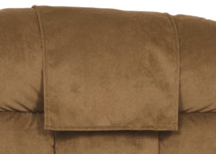 A close up of a brown couch with a headrest