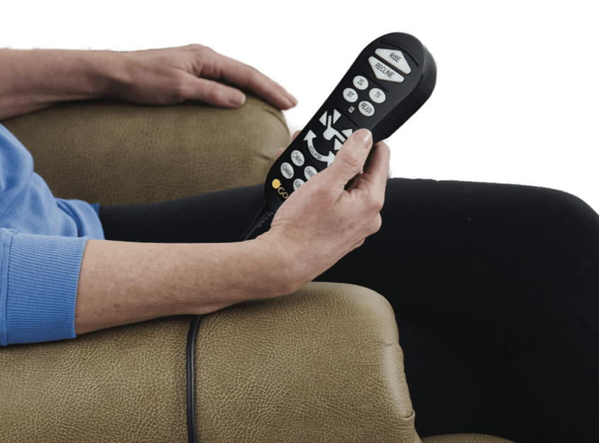 A person is sitting in a chair holding a remote control