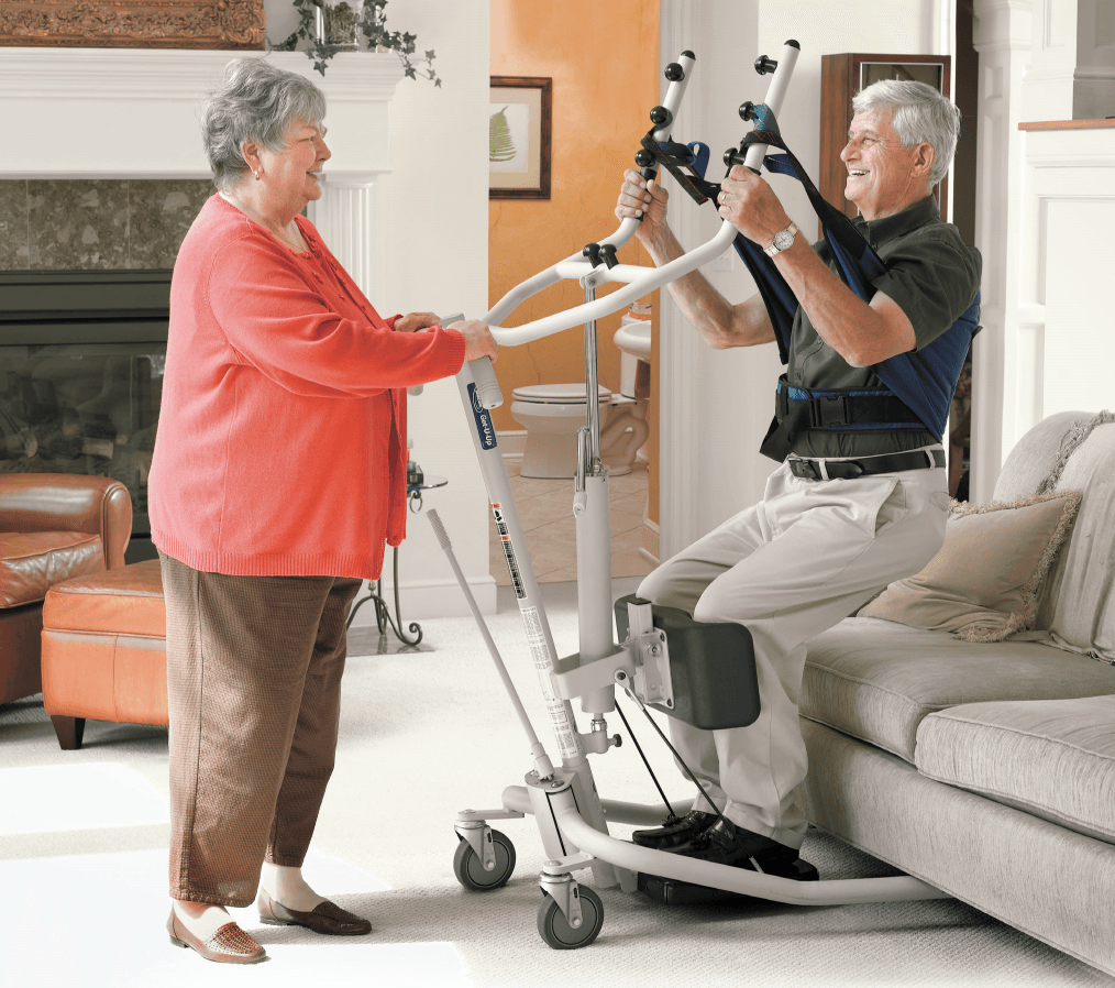 A man is being lifted by a woman in a living room