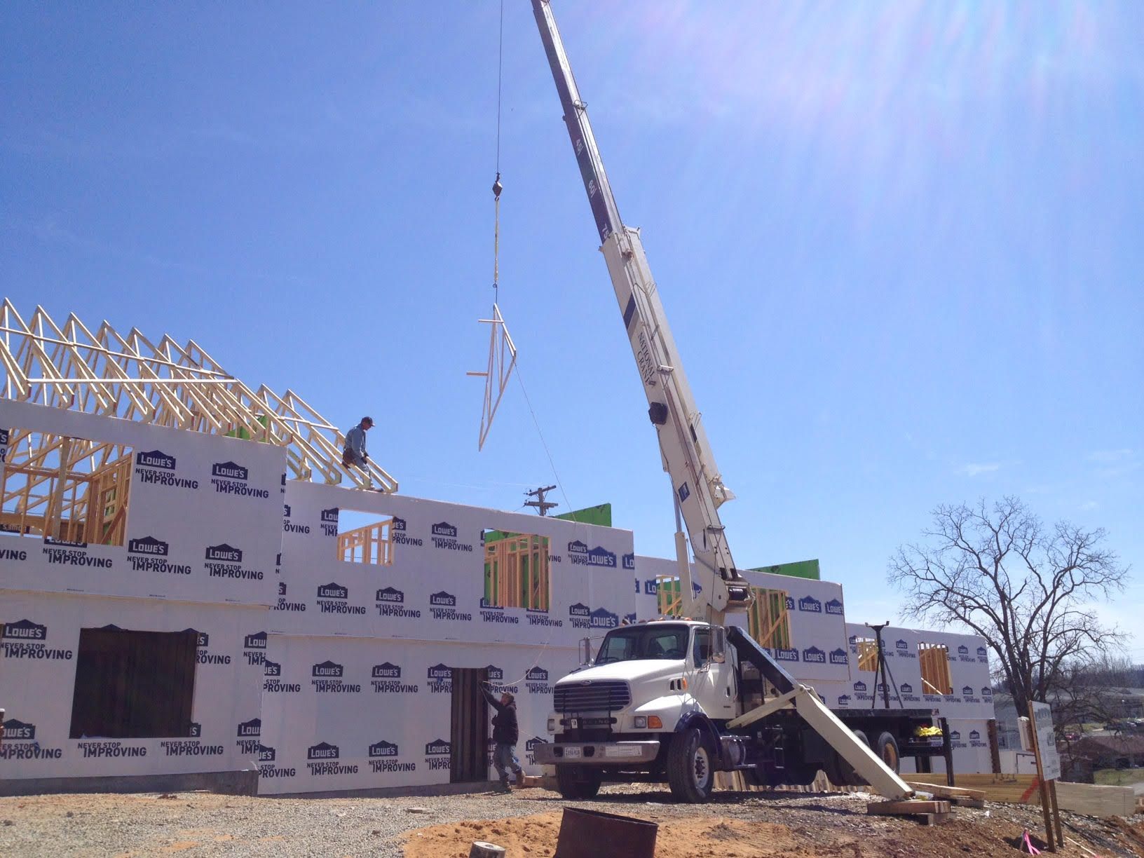 Shelton's Tree crane performing a rafter lift into new construction. Shelton's Tree crane performing a rafter lift into new construction.