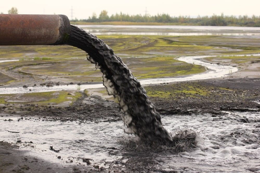 Pipe Pouring Dirty Water Into A Dirt Field — Kanga Bins Qld Pty Ltd In Mulara, QLD