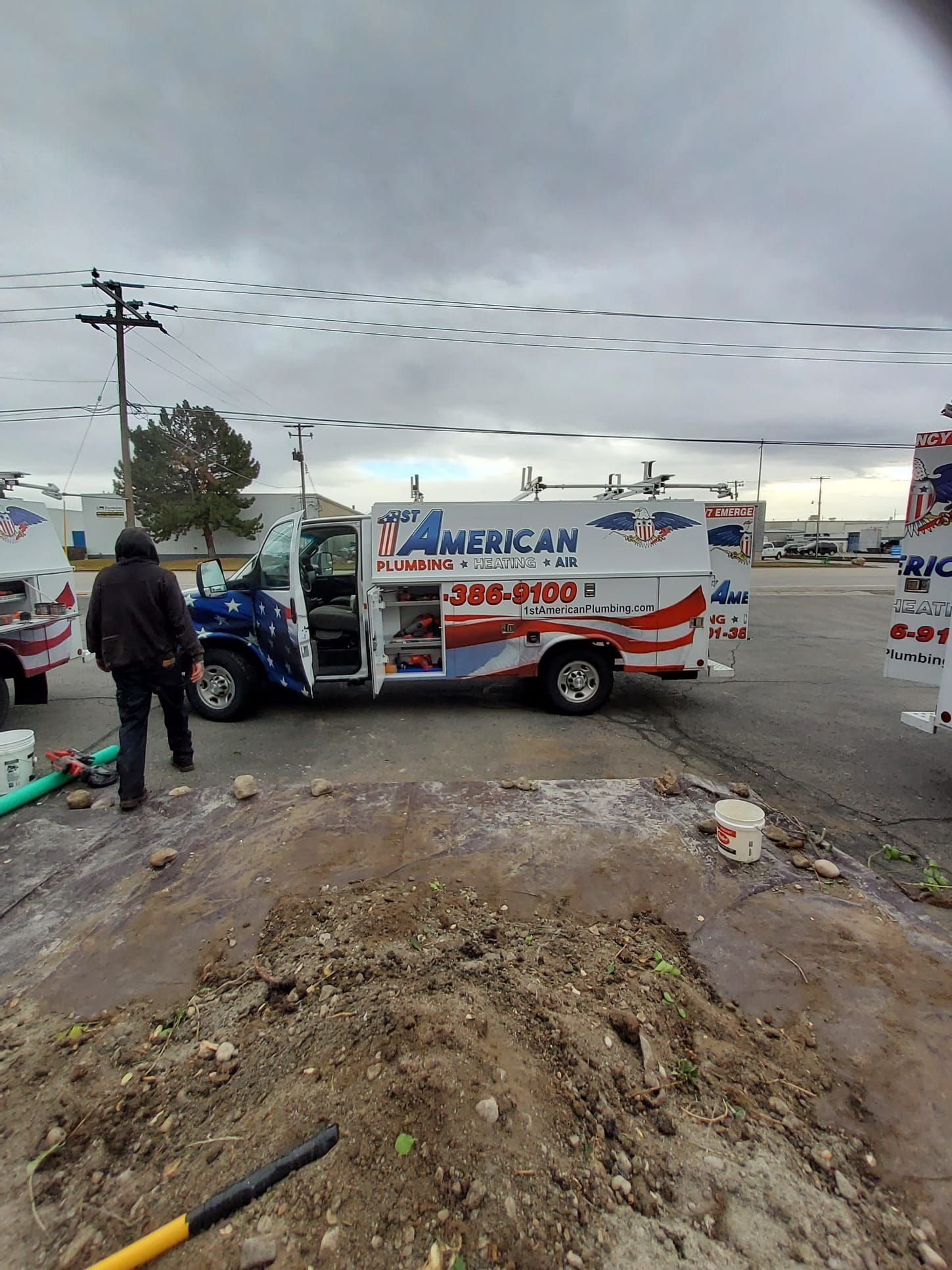 The 1st American service truck is parked outside a work site