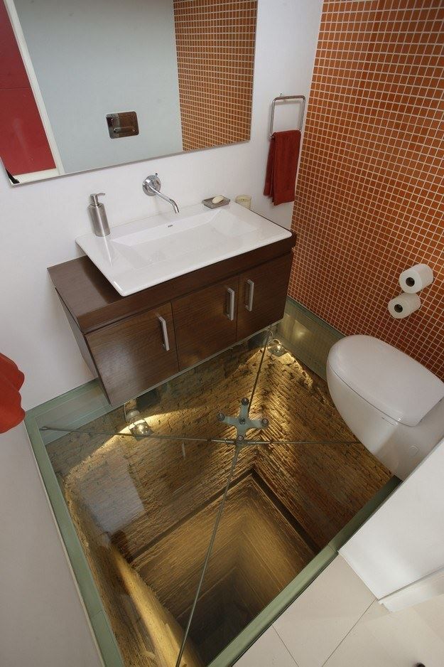 Bathroom with a vanity sink and a floor hatch opening to stairs below