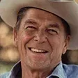 Ronald Reagan in a cowboy hat smiling.