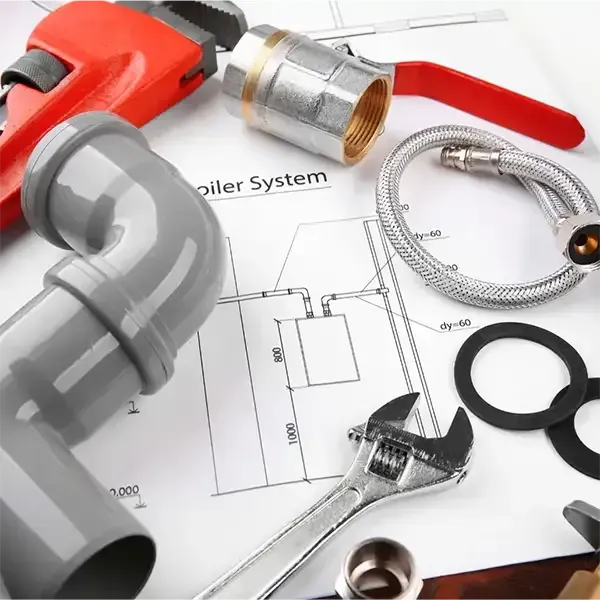 Plumbing tools and parts on a bathroom floor plan, including pipes, wrench, tape measure, and fittings