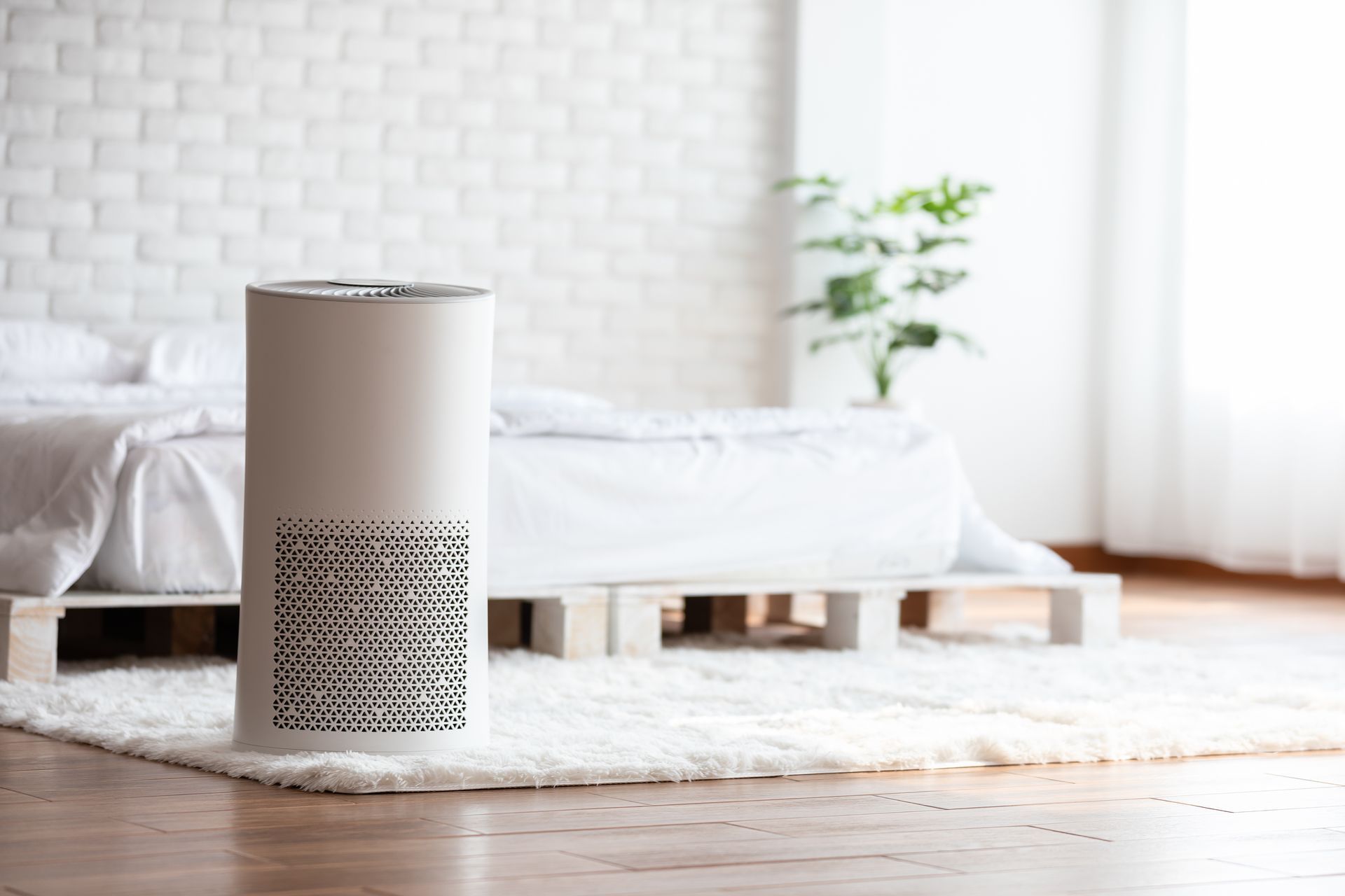 a large air filter sits at the end of a bed