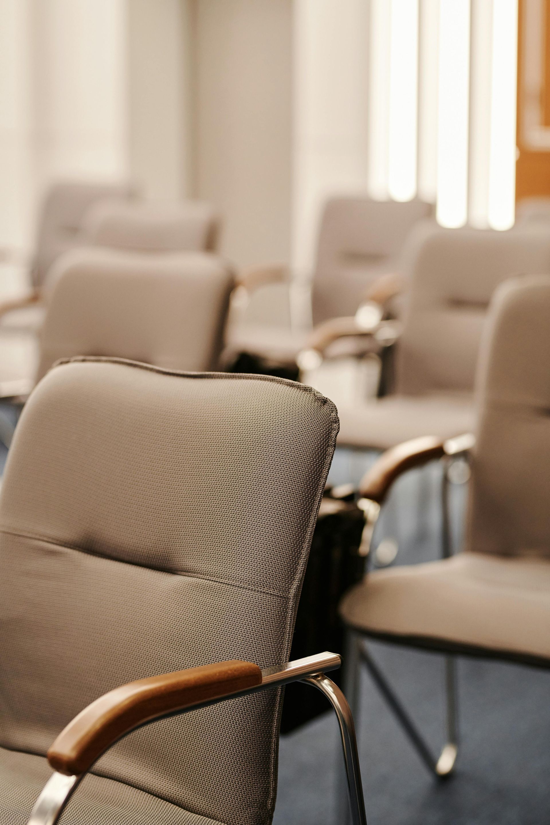 A row of chairs are lined up in a room.