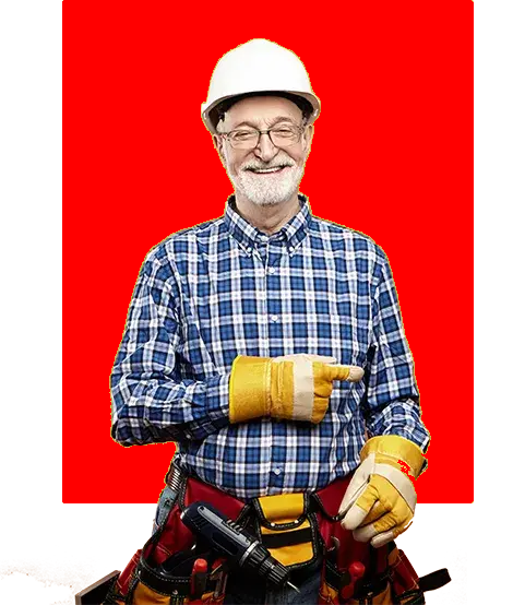 Un homme portant un casque et des gants se tient devant un fond rouge.