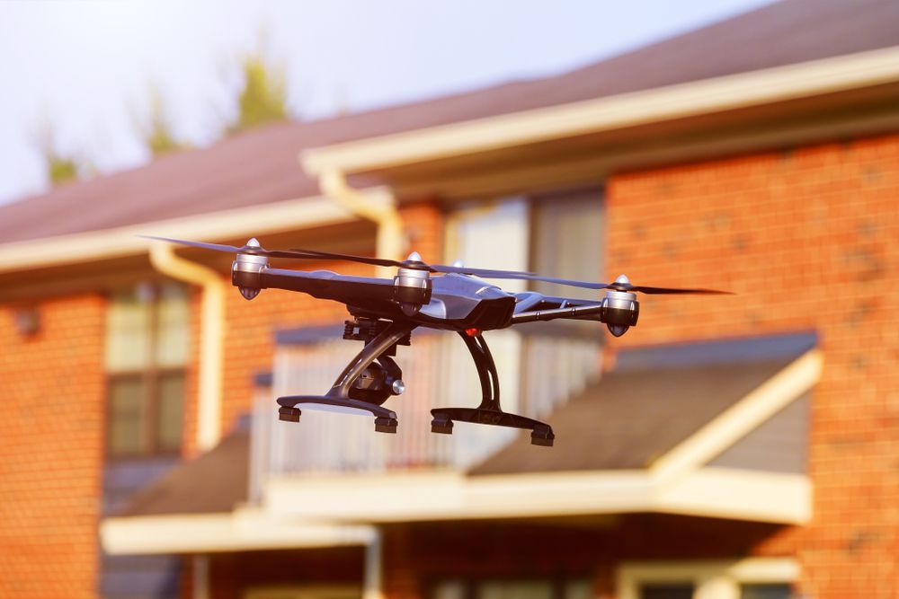 Drone in Flight Near a Brick House, Capturing Footage — Jetstream Aerial Services in Te Kowai, QLD
