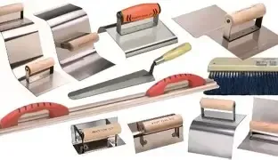 Assorted metal plastering tools with wooden and plastic handles.