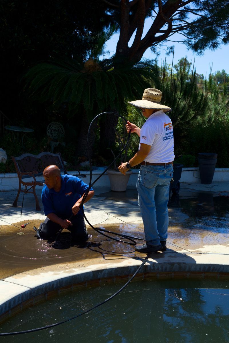 Pedro's Plumbing technician performing outdoor plumbing maintenance at a residential property in Los Angeles