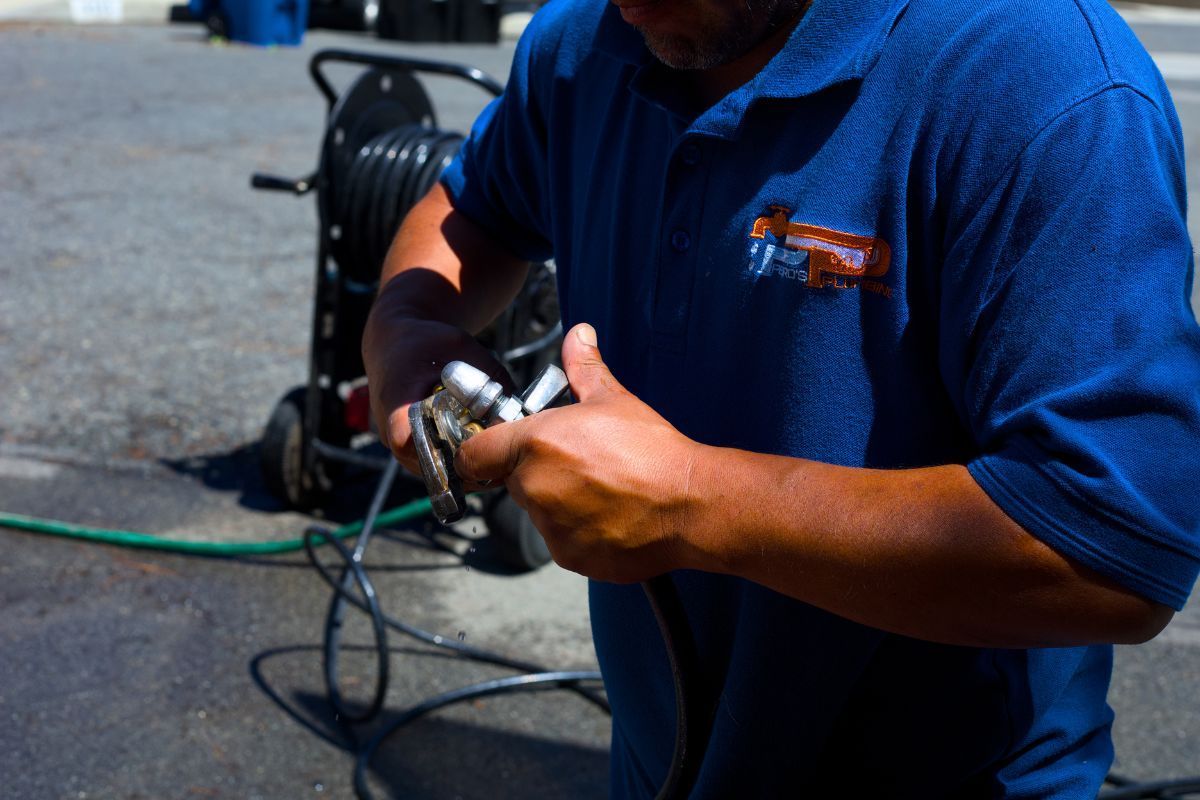 Licensed Pedro's Plumbing technician preparing professional plumbing equipment for a service call