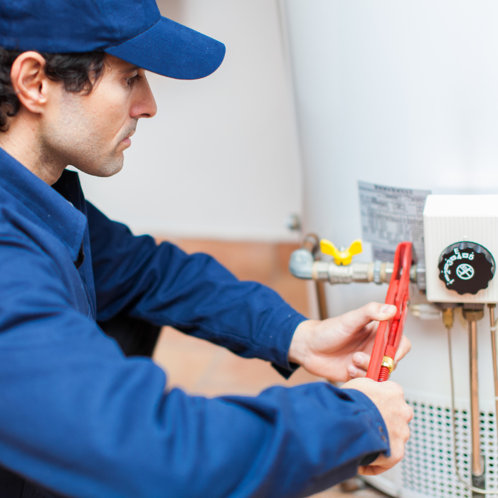 A plumber installing a water heater
