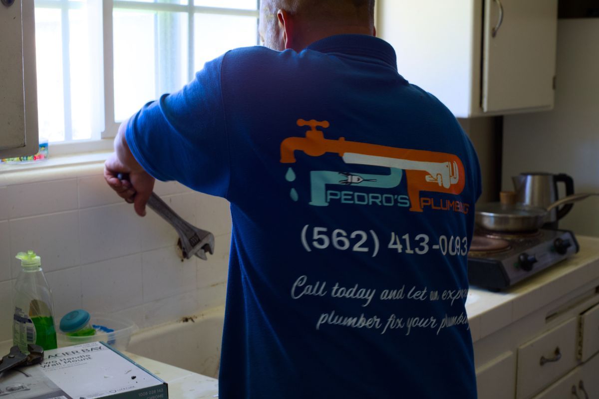 Pedro's Plumbing technician repairing a kitchen sink at a home in Los Angeles