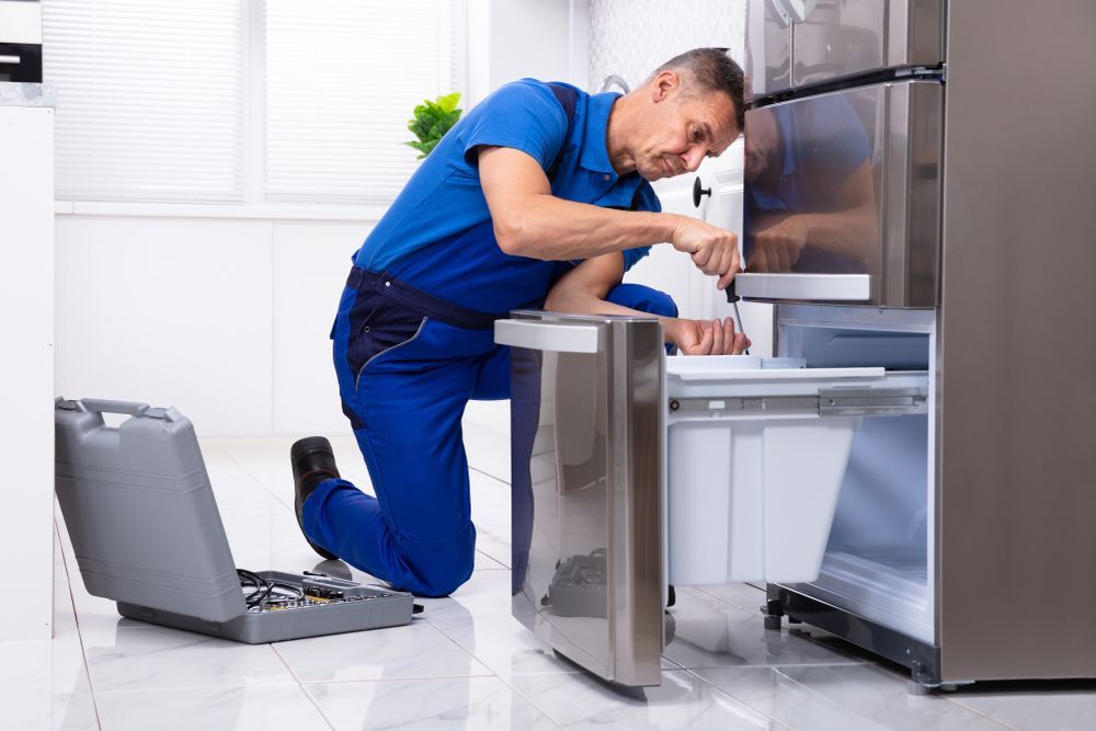 Electrician Repairing Refrigerator — PRO Solar & Electrical In Newcastle, NSW
