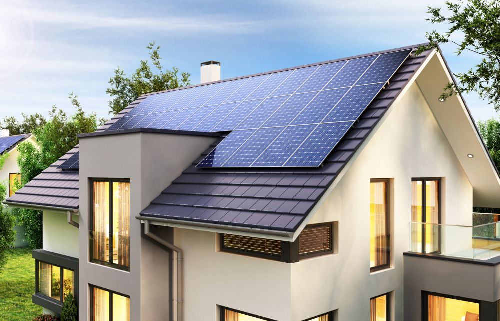 A House With A Lot Of Windows And Solar Panels On The Roof — PRO Solar & Electrical In Lake Macquarie, NSW