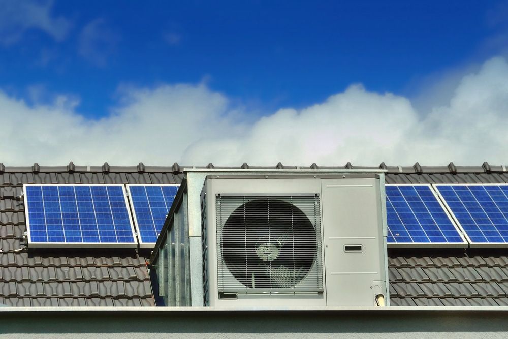 Solar panels on the roof with an air-conditioning unit — Solar System Installs in Newcastle NSW