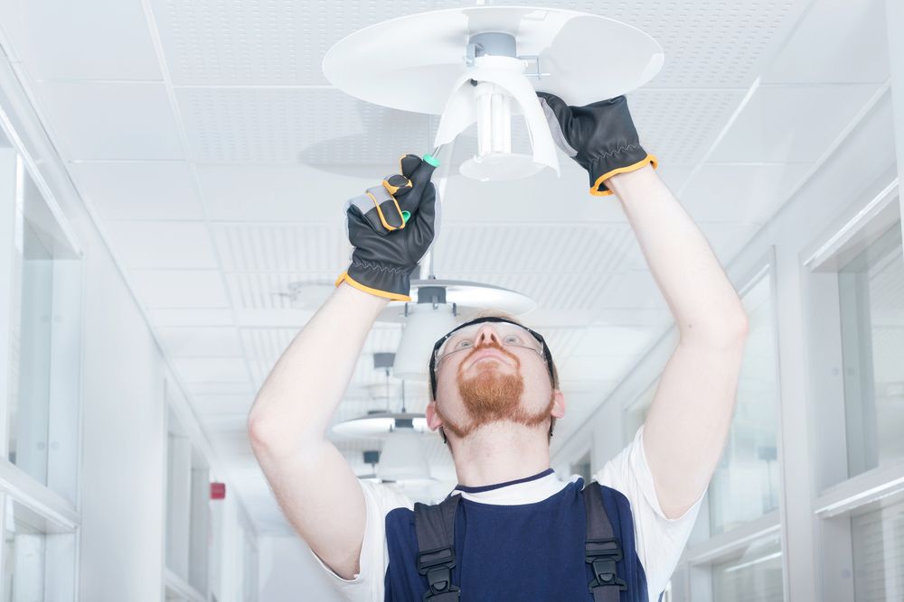 Changing Light Fixture Inside an Apartment Wall — Electricians in Newcastle NSW