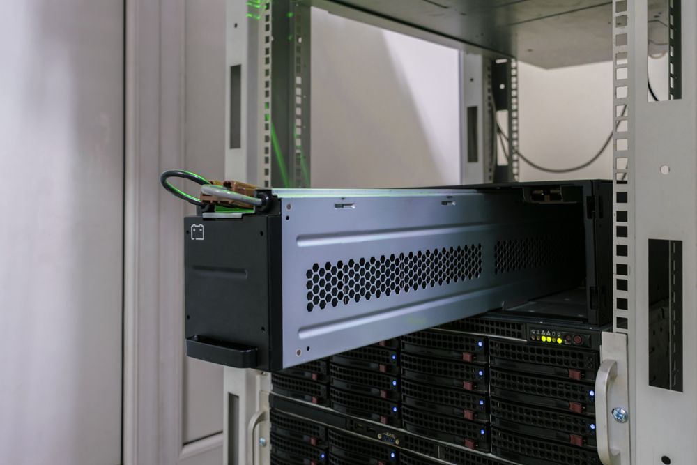 A Server Is Being Installed In A Rack In A Server Room — PRO Solar & Electrical In Port Stephens, NSW