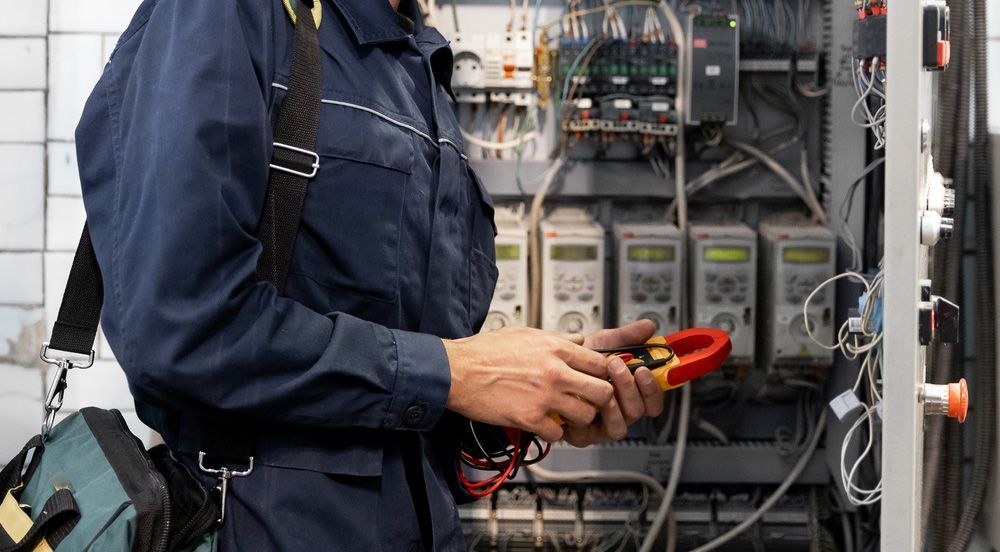 Electrician Checking Electrical Circuit In Control Panel — PRO Solar & Electrical In Maitland, NSW