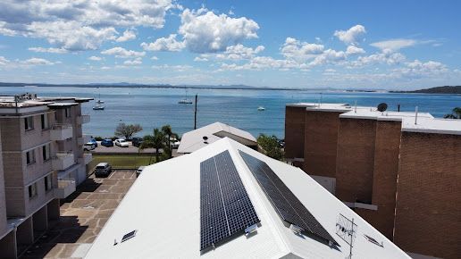 Solar Panel On A Red Roof Reflecting The Sun — PRO Solar & Electrical In Newcastle, NSW