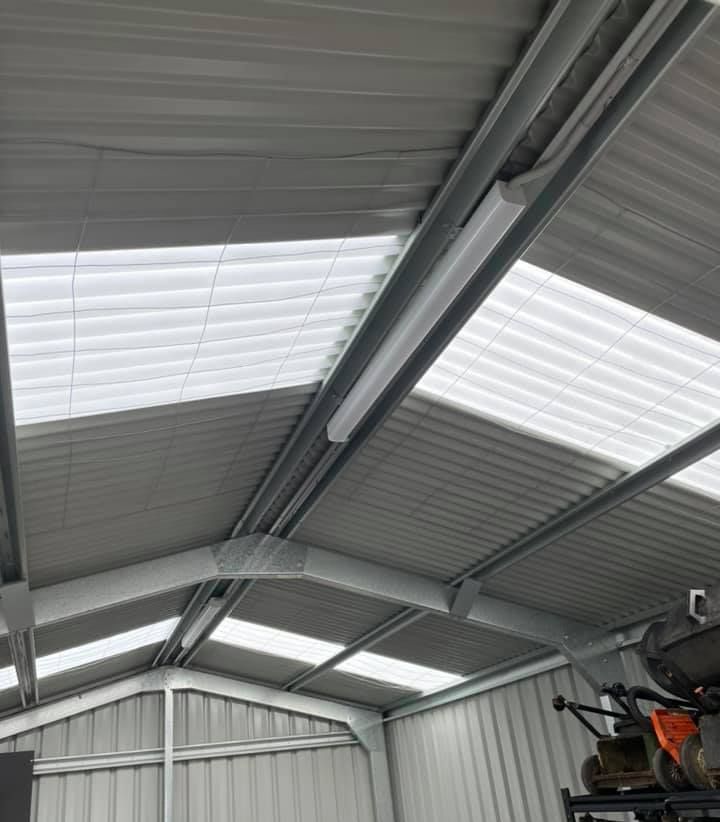 Electrician Installing Led Light Bulbs In Ceiling Lamp — PRO Solar & Electrical In Newcastle, NSW