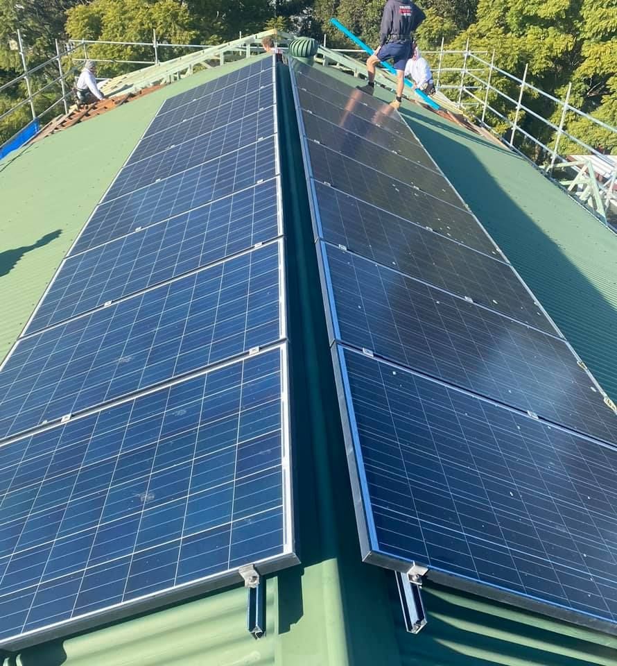 A Man Installing The Outdoor Solar Cell — PRO Solar & Electrical In Newcastle, NSW