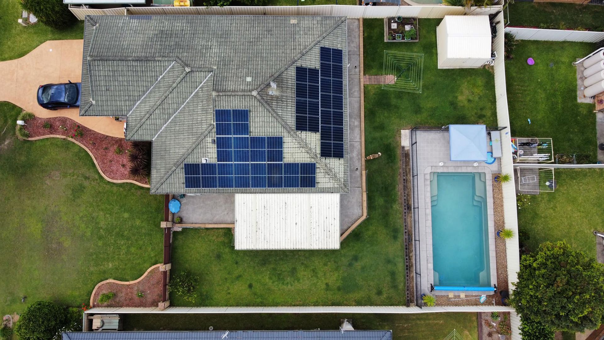 Top View Of A House With Solar Panels And Swimming Pools — PRO Solar & Electrical In Port Stephens, NSW