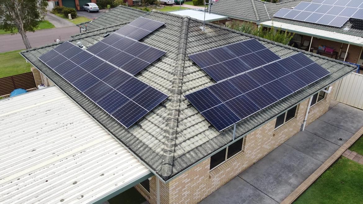 An Aerial View Of A House With Solar Panels On The Roof — PRO Solar & Electrical In Lake Macquarie, NSW
