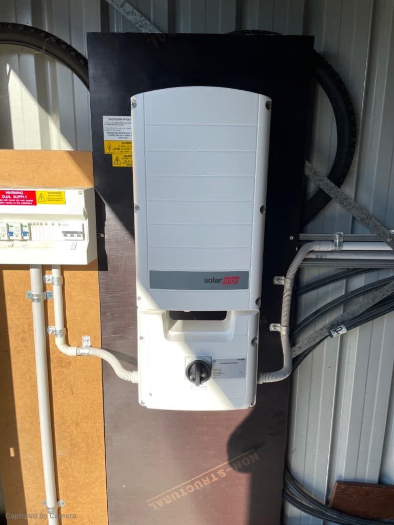 A Solar Panel Inverter Is Mounted On A Wall In A Shed — PRO Solar & Electrical In Maitland, NSW