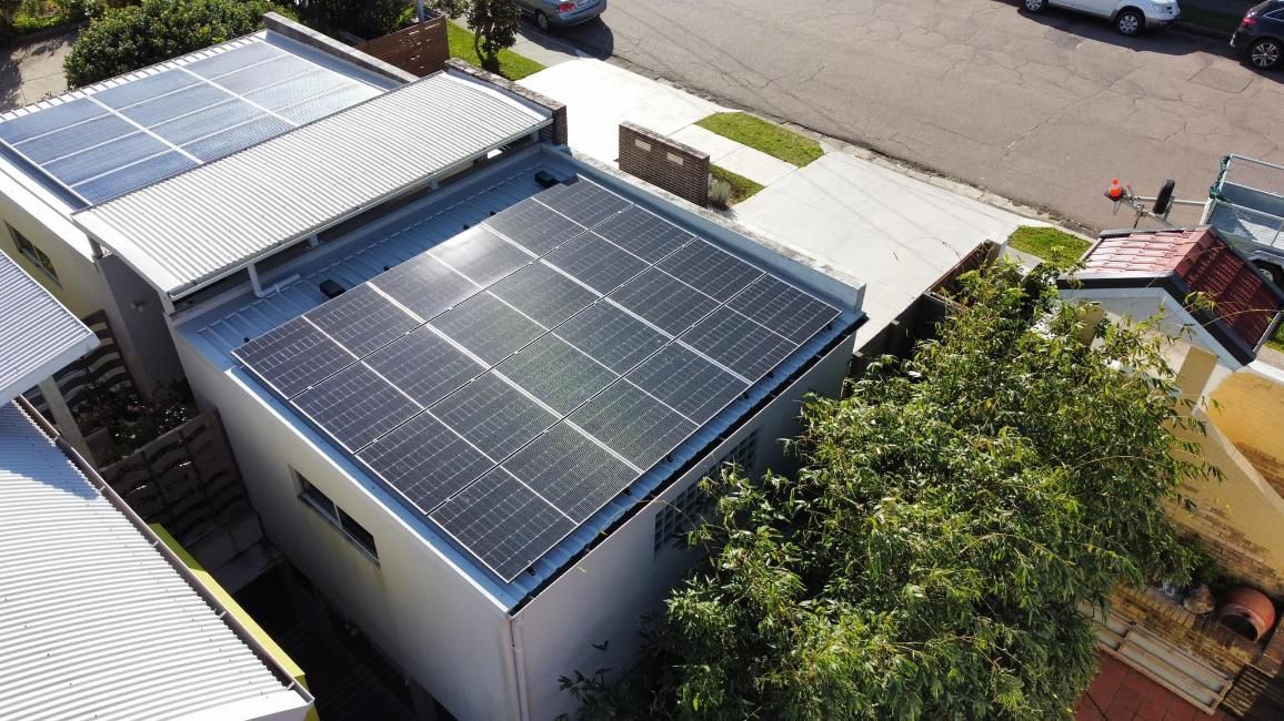 An Aerial View Of A House With Solar Panels On The Roof — PRO Solar & Electrical In Lake Macquarie, NSW