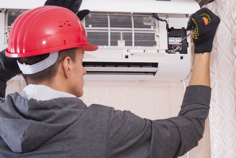 Electrician Servicing Air Conditioning Unit — PRO Solar & Electrical In Port Stephens, NSW